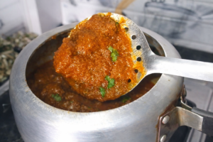 Hot and spicy Masala Kaleji curry prepared with onion masala and whole spices, garnished with fresh coriander