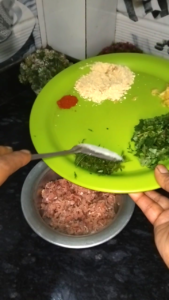 Mixing spices and ingredients into keema for kofta preparation