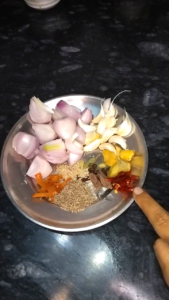 Grinding fresh spices and ingredients to make keema kofta curry masala paste