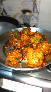Deep frying keema koftas in hot oil until golden brown