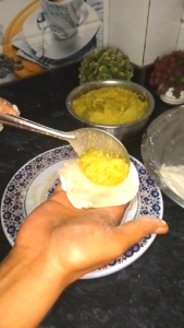 फरा बनाने के लिए आटे में भरावन भरने की प्रक्रिया