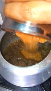 Fresh whole spice masala paste being added to fried kaleji and onion for Masala Kaleji recipe