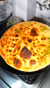 Crispy Cooked Matar Paratha Removing from Tawa