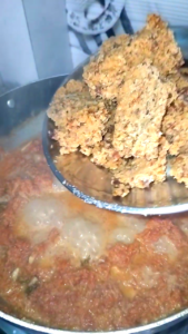 Adding khoya to Gajar Ka Halwa while cooking