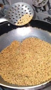 Roasting white sesame seeds in a pan for til chikki recipe