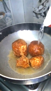 Melting jaggery in a pan for til chikki recipe