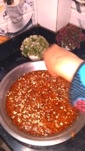 Garnishing til chikki with chopped dry fruits on top