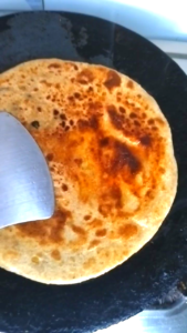 Cooking chana dal paratha with desi ghee