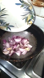 Sliced Onions Added to Hot Oil for White Chicken Recipe