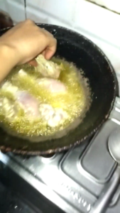 Marinated Chicken Added to Hot Oil for White Chicken Recipe