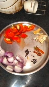 Roughly chopped onions, tomatoes, ginger, garlic and whole spices for Dhaba Style Matar Paneer Recipe