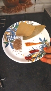 Tempering with Cumin Bay Leaf Cinnamon and Dry Red Chilies for Matar Paneer