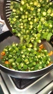 Adding Chopped Bhindi to Onions for Bhindi Recipe