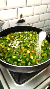 Adding Salt and Covering Bhindi to Cook Until Soft